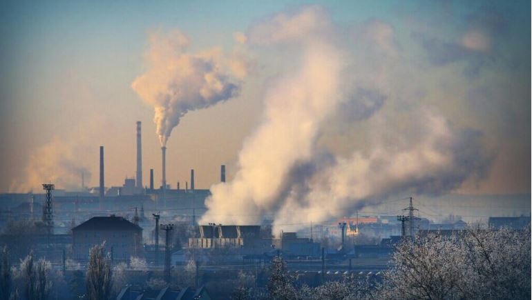 Smokestacks billowing smoke from factory